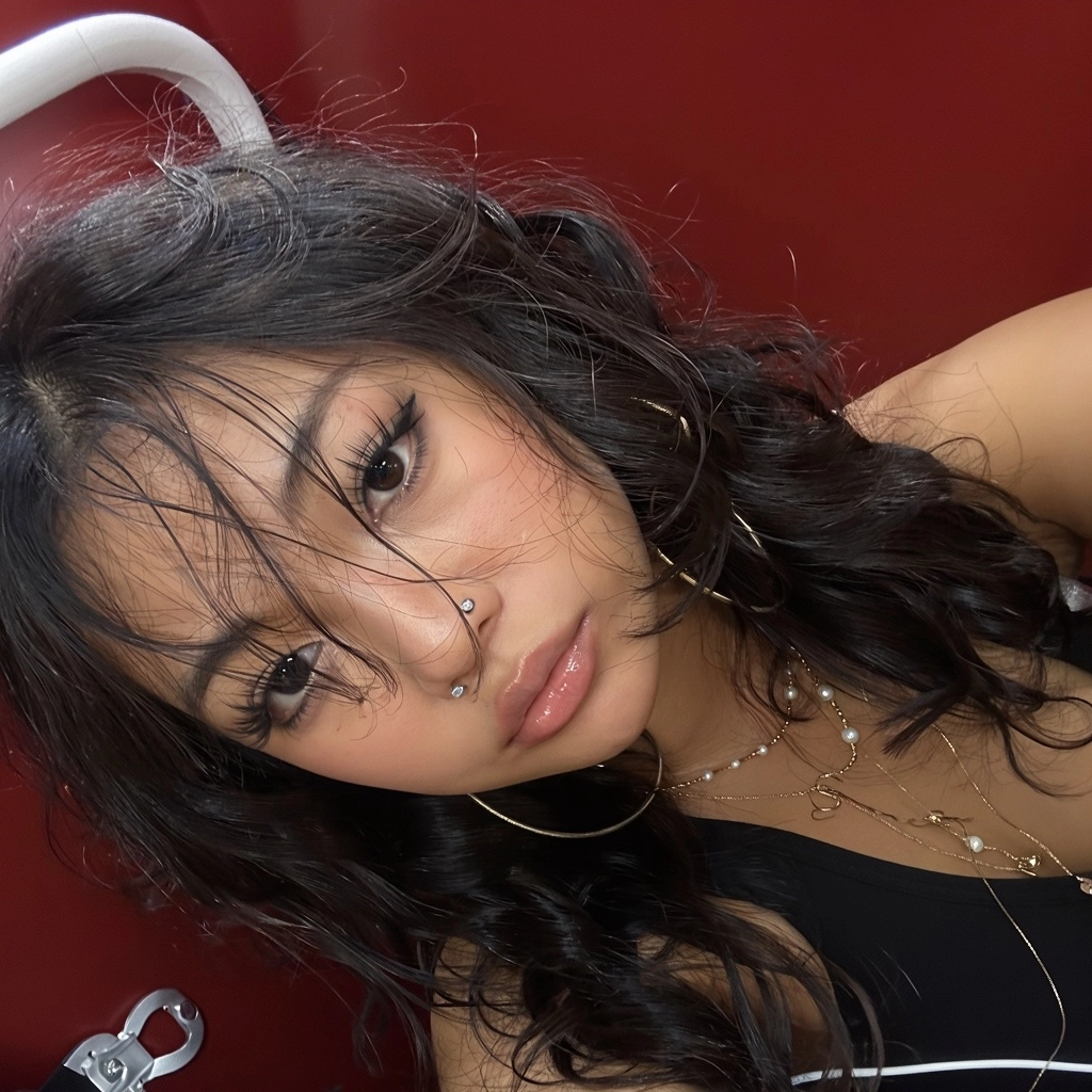 Extremely tilted close-up smartphone selfie of a young East Asian woman in her late teens or early 20s, face rotated alm